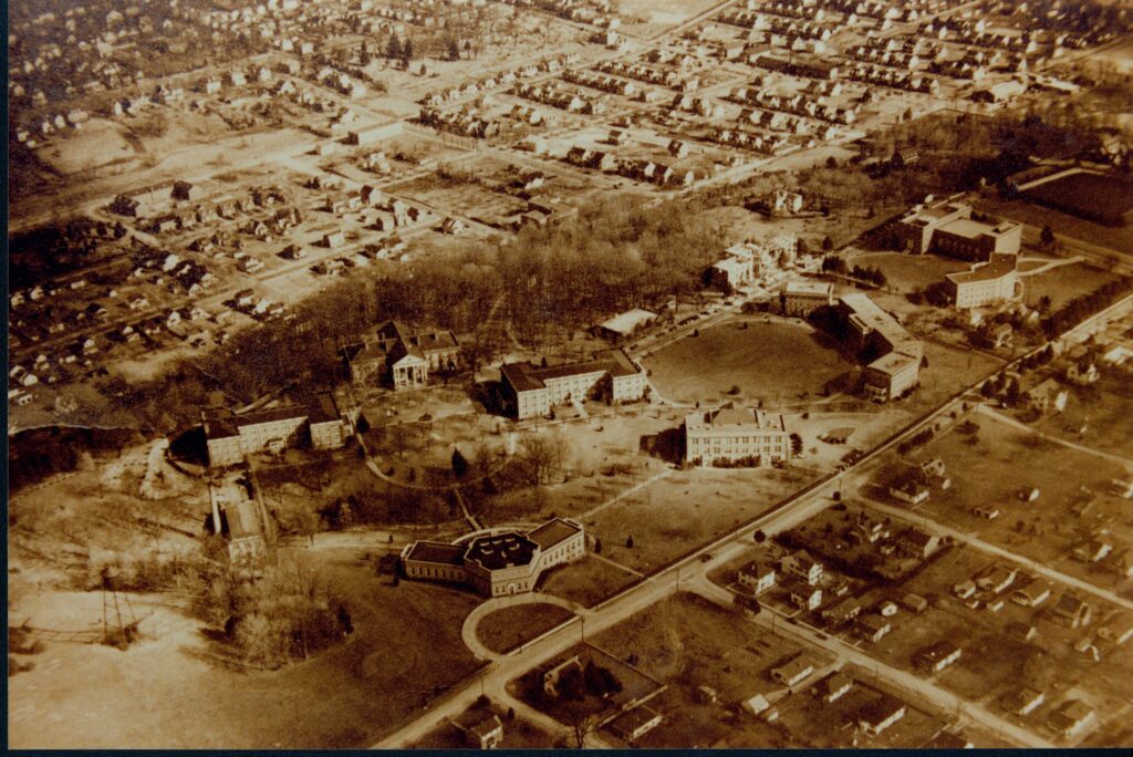A black and white photo of an aerial view of campus showing Seacobeck, Williard, Monroe, Virginia, Chandler, Custic, Ball, Trinkle, George Washington and Westmoreland Halls as well as the laundry building and Marye, Tyler and Fairfax houses. 