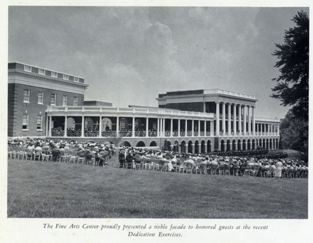 A black and white photo showing a large crowd of people (A couple hundred strong) sitting out front of the Fine Arts Center (Dupont, Pollard and Melchers) in folding chairs. There is text below the picture that says "The Fine Arts Center proudly presented a noble facade to honored guests at the recent Dedication Exercises."