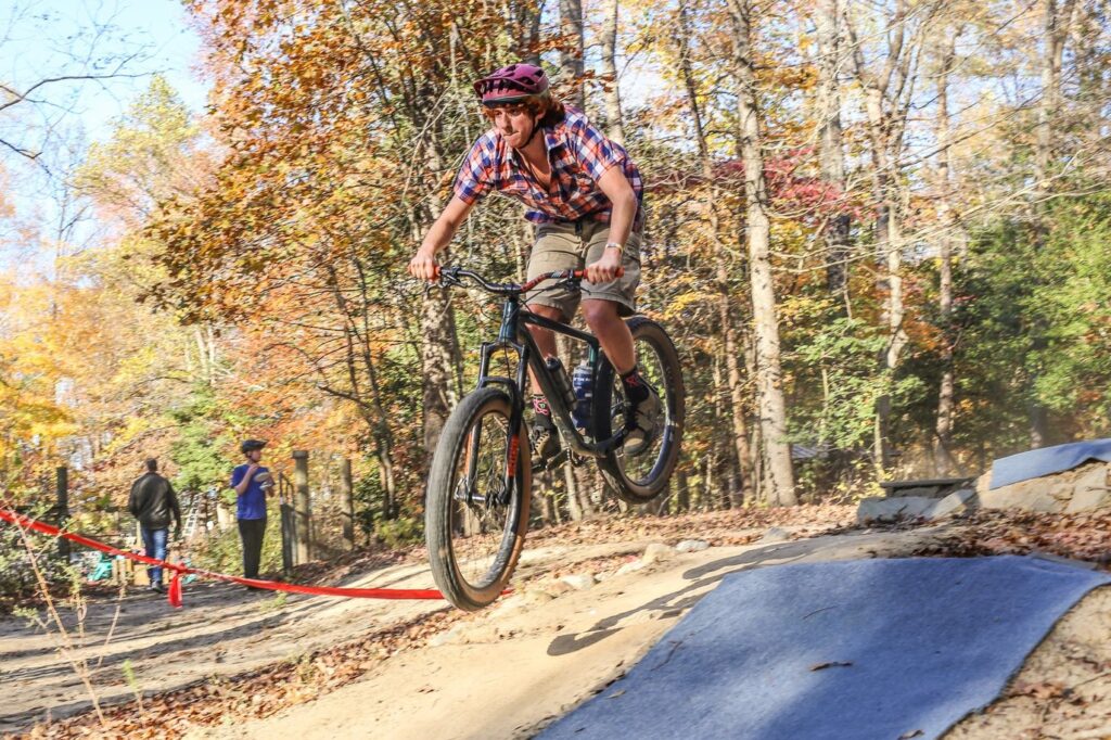 A photo of Max Steinbaum, a Historic Preservation major, jumping his bike "Barney."